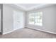 Comfortable bedroom with carpet has a double door closet and natural light at 4041 Ash Tree St, Snellville, GA 30039