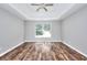 Spacious bedroom with tray ceiling features wood floors and a large window at 4041 Ash Tree St, Snellville, GA 30039