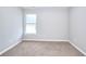 Carpeted bedroom featuring a window, neutral color scheme, and bright natural light at 4041 Ash Tree St, Snellville, GA 30039