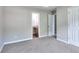 Bedroom with ensuite bathroom, closet, and carpeted floors at 4041 Ash Tree St, Snellville, GA 30039