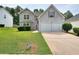 Charming two-story home features a stone accent facade, a well-manicured lawn, and a two-car garage at 4041 Ash Tree St, Snellville, GA 30039