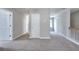 Upstairs carpeted hallway with white doors, railings and trim shows access to multiple rooms at 4041 Ash Tree St, Snellville, GA 30039