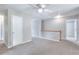 Carpeted hallway features a ceiling fan, several white doors, and a white railing at 4041 Ash Tree St, Snellville, GA 30039