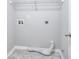 Functional laundry room equipped with tile floor, overhead shelving and washer/dryer hookups at 4041 Ash Tree St, Snellville, GA 30039