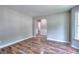 Living room featuring neutral paint, hardwood flooring, and open layout at 4041 Ash Tree St, Snellville, GA 30039