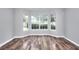 Bright living area boasts large bay windows and hardwood floors, creating a welcoming and airy atmosphere at 4041 Ash Tree St, Snellville, GA 30039