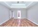 Large main bedroom featuring tray ceiling, hardwood flooring, and ensuite bathroom at 4041 Ash Tree St, Snellville, GA 30039