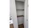 Bathroom linen closet with a white interior and wood shelves at 681 Burtons Cv, Hampton, GA 30228