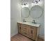 Bathroom showcasing a double sink vanity with white marble countertops and wood cabinets at 681 Burtons Cv, Hampton, GA 30228