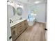 Bright bathroom featuring a soaking tub, walk-in shower, double vanity, and modern fixtures at 681 Burtons Cv, Hampton, GA 30228