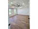 Primary bedroom featuring tray ceiling, ceiling fan, and wood flooring at 681 Burtons Cv, Hampton, GA 30228