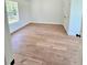 Bedroom with wood-look floors, window, closet and natural light at 681 Burtons Cv, Hampton, GA 30228