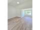 Bedroom with vaulted ceilings, plank floors, a closet and a large window providing natural light at 681 Burtons Cv, Hampton, GA 30228