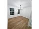 Light-filled dining room with hardwood floors and modern chandelier at 681 Burtons Cv, Hampton, GA 30228