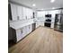 Open kitchen with white cabinetry, stainless steel appliances, and quartz countertops at 681 Burtons Cv, Hampton, GA 30228