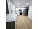 Modern kitchen with white cabinets, stainless steel appliances, and quartz countertops at 681 Burtons Cv, Hampton, GA 30228
