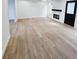 Bright living room featuring hardwood floors and a cozy fireplace at 681 Burtons Cv, Hampton, GA 30228