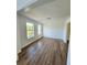 Living room showcasing hardwood flooring and natural light from the windows at 681 Burtons Cv, Hampton, GA 30228
