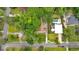 Aerial view of a home on a large lot, surrounded by mature trees and other homes at 124 Chaseland Rd, Atlanta, GA 30328