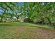 Spacious backyard with mature trees and partial fence at 124 Chaseland Rd, Atlanta, GA 30328