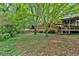 Private wooded backyard with a low stone wall and plenty of green space at 124 Chaseland Rd, Atlanta, GA 30328
