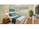 Comfortable bedroom featuring a large window with shutters, neutral walls and hardwood floors at 124 Chaseland Rd, Atlanta, GA 30328