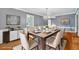 Elegant dining room featuring a chandelier, a table with seating for six, and hardwood floors at 124 Chaseland Rd, Atlanta, GA 30328