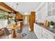 Bright kitchen boasts wood cabinets, stone countertops, tile floors, and a breakfast nook with backyard views at 124 Chaseland Rd, Atlanta, GA 30328