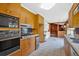 Functional kitchen features wood cabinets, stainless steel appliances, and an adjacent room for added space at 124 Chaseland Rd, Atlanta, GA 30328