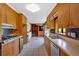 Functional kitchen features wood cabinets, stainless steel appliances, tile backsplash, and an adjacent room at 124 Chaseland Rd, Atlanta, GA 30328