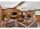 Cozy living room with wood walls, brick fireplace, comfortable seating, and natural light at 124 Chaseland Rd, Atlanta, GA 30328
