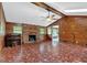 Spacious living room with wood walls, brick fireplace, and ample space for furniture arrangement at 124 Chaseland Rd, Atlanta, GA 30328