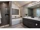 Modern bathroom featuring a soaking tub, glass-enclosed shower, and double vanity with sleek countertops at 145 Silver Mine Trl, Austell, GA 30168