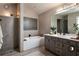 Bathroom featuring a walk-in shower, tub, and a dual vanity with decor at 145 Silver Mine Trl, Austell, GA 30168