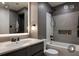 Modern bathroom featuring a gray tile shower, bathtub, and vanity with sleek fixtures at 145 Silver Mine Trl, Austell, GA 30168