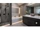 Contemporary bathroom showcasing a glass shower, undermount tub, and double sink vanity with stylish lighting at 145 Silver Mine Trl, Austell, GA 30168