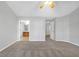 A carpeted bedroom featuring gray walls, a ceiling fan, and a view of the ensuite bathroom at 145 Silver Mine Trl, Austell, GA 30168