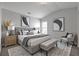 Well-lit bedroom features a gray upholstered bed, vaulted ceiling, bench, and tasteful decor at 145 Silver Mine Trl, Austell, GA 30168