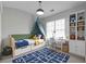 Bright bedroom with a unique daybed, desk and bookshelves at 145 Silver Mine Trl, Austell, GA 30168