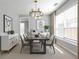 Contemporary dining room with modern light fixture, stylish furniture, and ample natural light at 145 Silver Mine Trl, Austell, GA 30168
