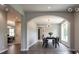 Bright dining room featuring modern light fixture, beautiful archway, and natural light from the large window at 145 Silver Mine Trl, Austell, GA 30168