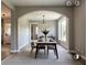 Bright dining room featuring modern light fixture, beautiful archway, and natural light from the large window at 145 Silver Mine Trl, Austell, GA 30168