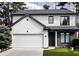 Contemporary home showcasing white stucco, contrasting trim, and an attached two-car garage at 145 Silver Mine Trl, Austell, GA 30168