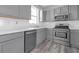 Kitchen boasts stainless steel appliances, sleek countertops, and gray cabinetry at 145 Silver Mine Trl, Austell, GA 30168