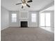 Spacious living room with fireplace, lots of natural light, and carpet flooring at 145 Silver Mine Trl, Austell, GA 30168