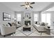Comfortable living room featuring a cozy fireplace, a ceiling fan, and neutral tones at 145 Silver Mine Trl, Austell, GA 30168