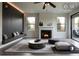 Modern living room with a sleek fireplace, bench seating, and large windows at 145 Silver Mine Trl, Austell, GA 30168