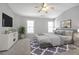 Modern bedroom featuring a ceiling fan and large windows for ample natural light at 145 Silver Mine Trl, Austell, GA 30168