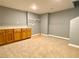 Finished basement area with cabinets and carpet flooring, perfect for storage or entertainment at 148 Paradise Xing, Douglasville, GA 30134