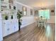 Bright dining area featuring wood floors, wainscoting, modern light fixtures, and a sun-lit window at 148 Paradise Xing, Douglasville, GA 30134